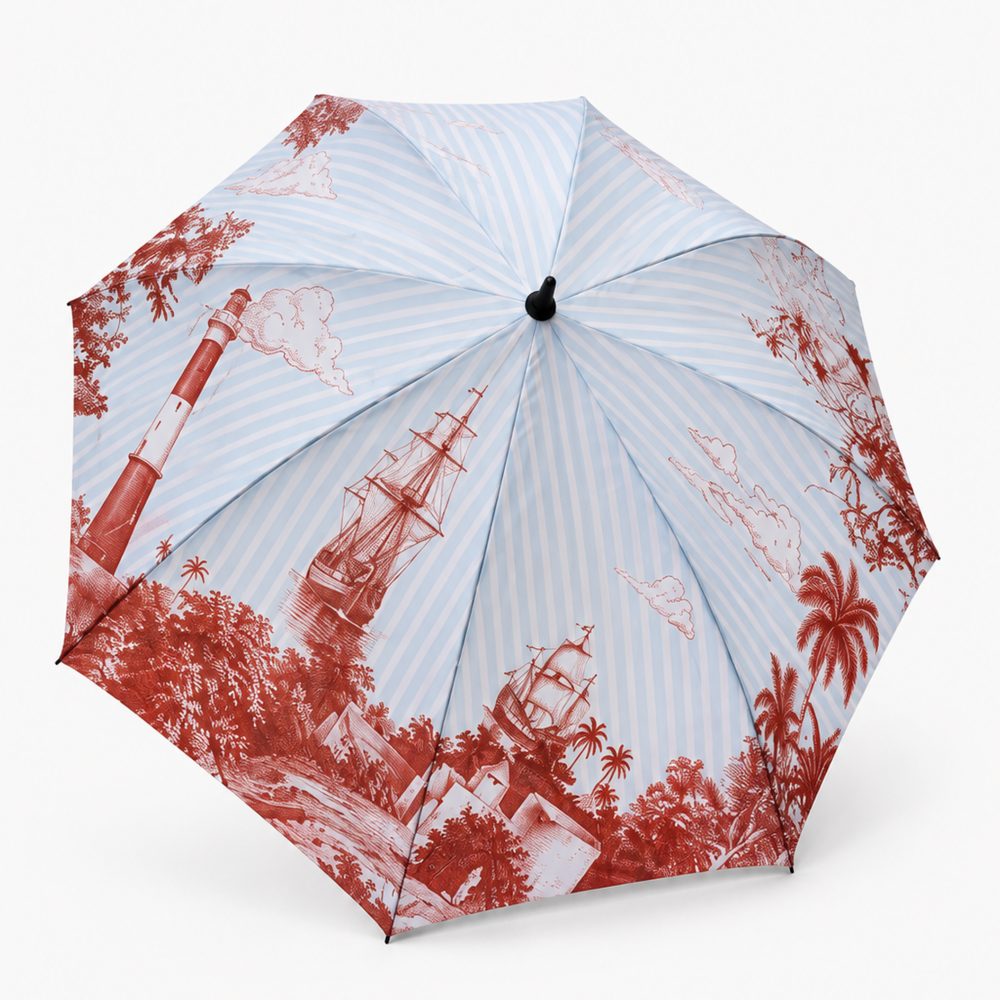 The Bombay Ballad umbrella, a sixty inch powder-blue striped golf canopy illustrated with lighthouses, ships and palms